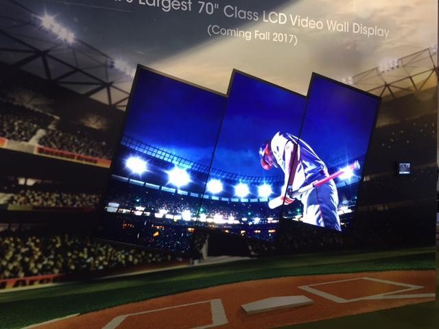 A video wall made up of 3 70 inch LCD video display panels, displaying a baseball player in a stadium