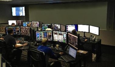 A control room with workers at their workstations