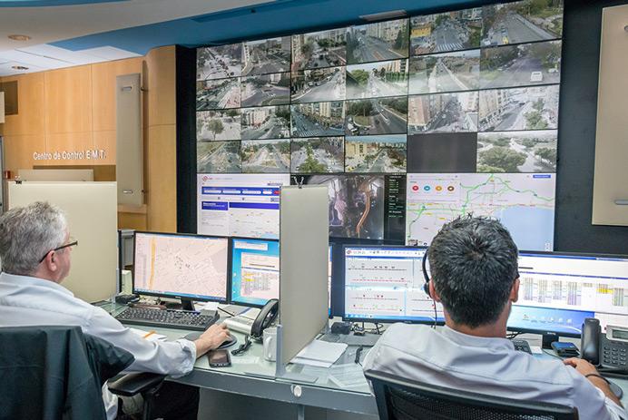 EMT Madrid Control room with two workers monitoring roads and data displayed on a video wall