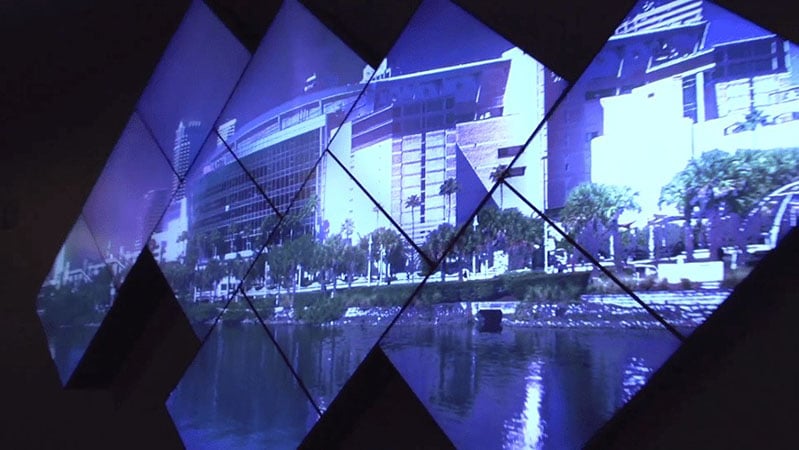 Artistic video wall displaying a photo of the Amalie Arena along the shore of a body of water