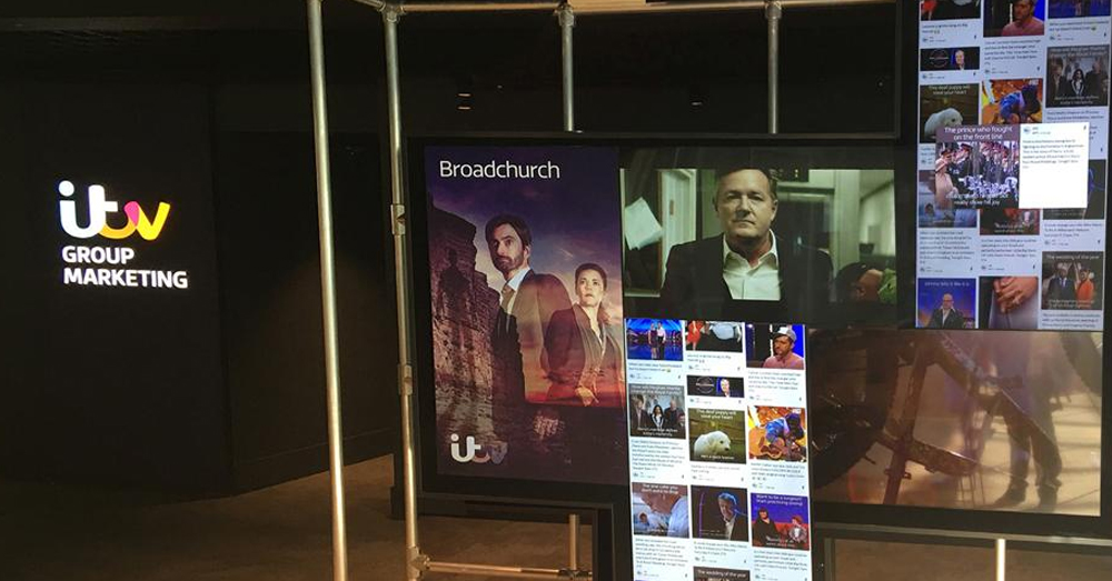 Artistic video wall mosiac displaying show posters, shows, and social media content at the itv Group Marketing office