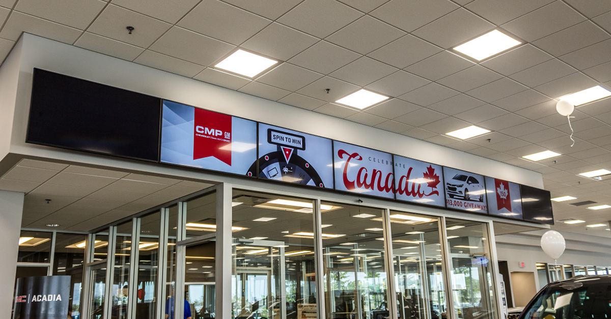 Video wall displaying car advertisement in a Kaizen Automotive Group owned dealership