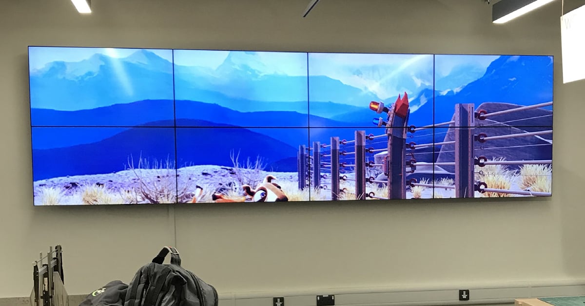 8 panel video wall in classroom displaying a cartoon