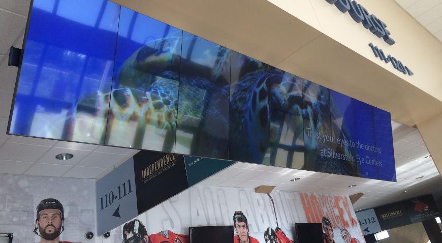 Hanging video wall in a mall displaying an advertisement for Silverstein Eye Centers
