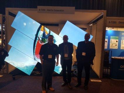 3 Userful employees in front of a mosaic video wall at ISE 2018 Amsterdam