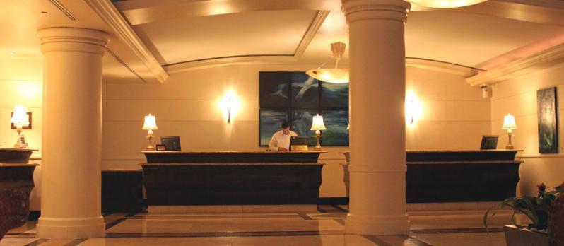 Building reception lobby, with receptionist behind desk and an artistic video wall behind them