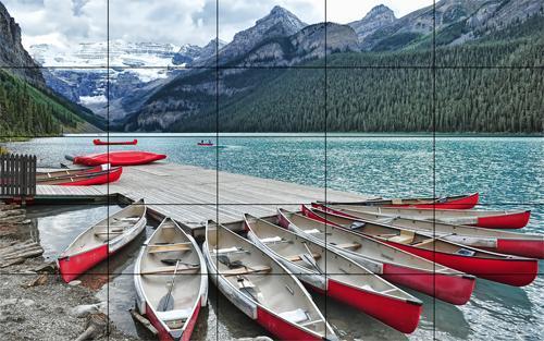 A photo of Lake Louise and its dock with red boats, on a 5 by 5 panel video wall