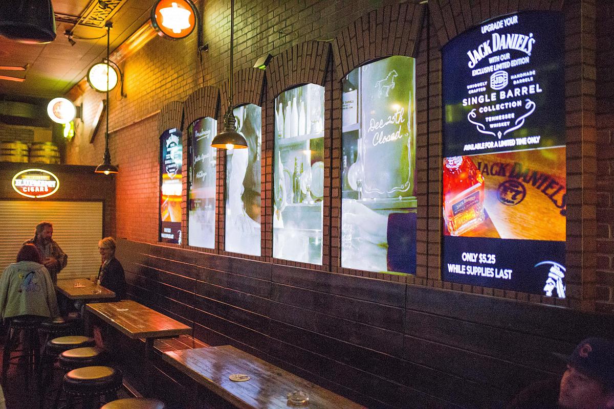 Window style video walls in Smokin' Joe's Pub, displaying advertisements and visual art