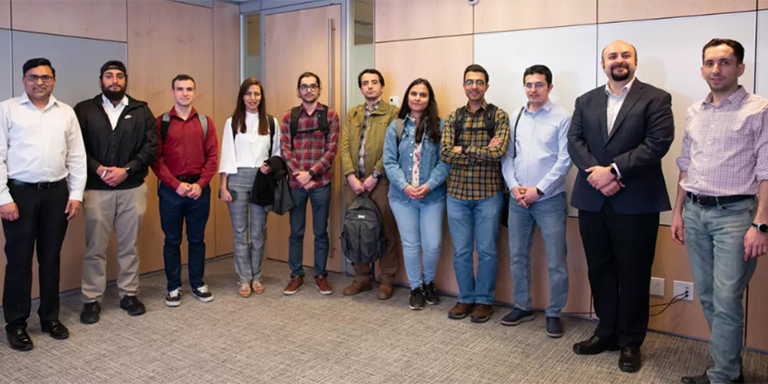 Group of University of Calgary students and Userful employees in boardroom.
