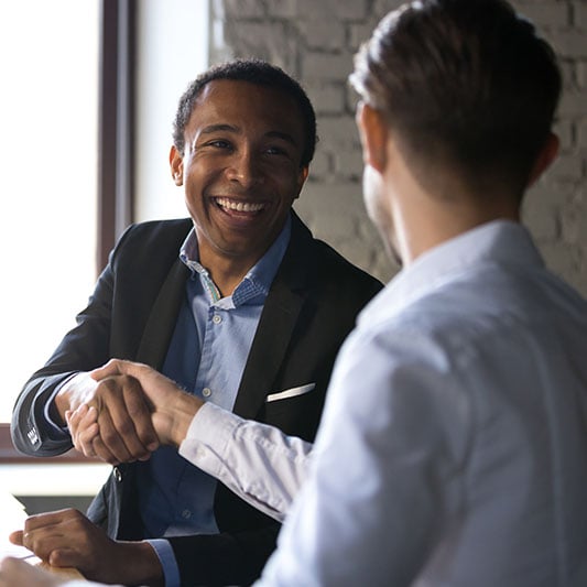 partners shaking hands, in office