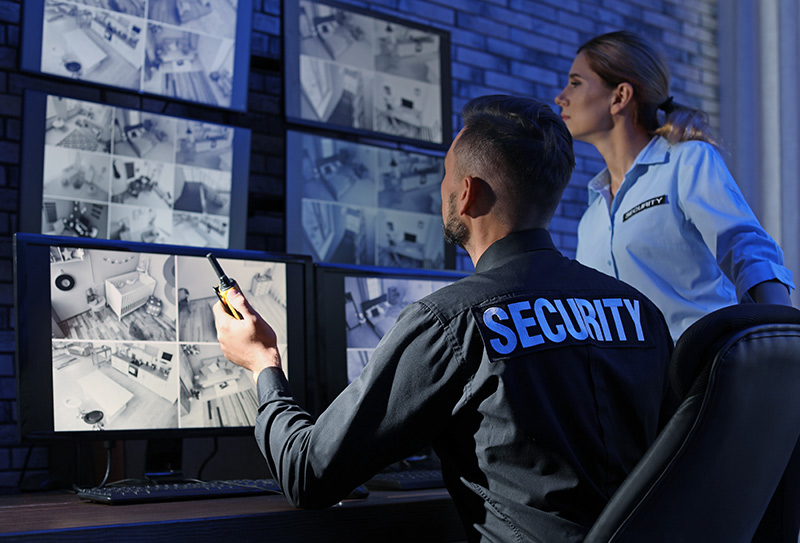 security reviewing cameras on screens